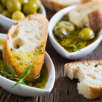 The bread dipped in olive oil with herbs and spices
