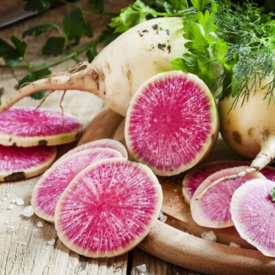 Cut pink radish, vintage wooden background