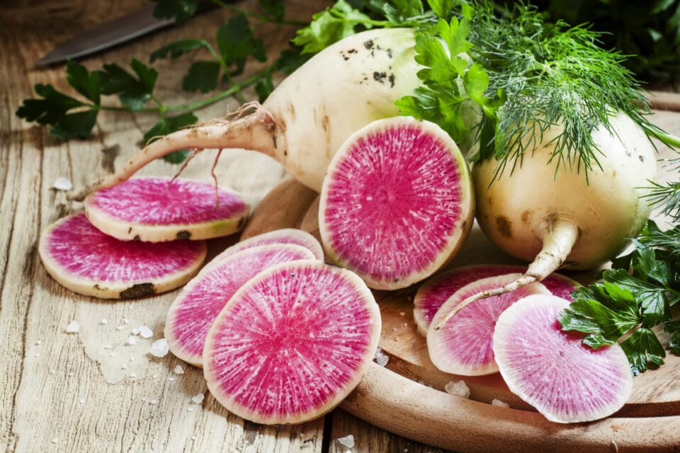 Cut pink radish, vintage wooden background