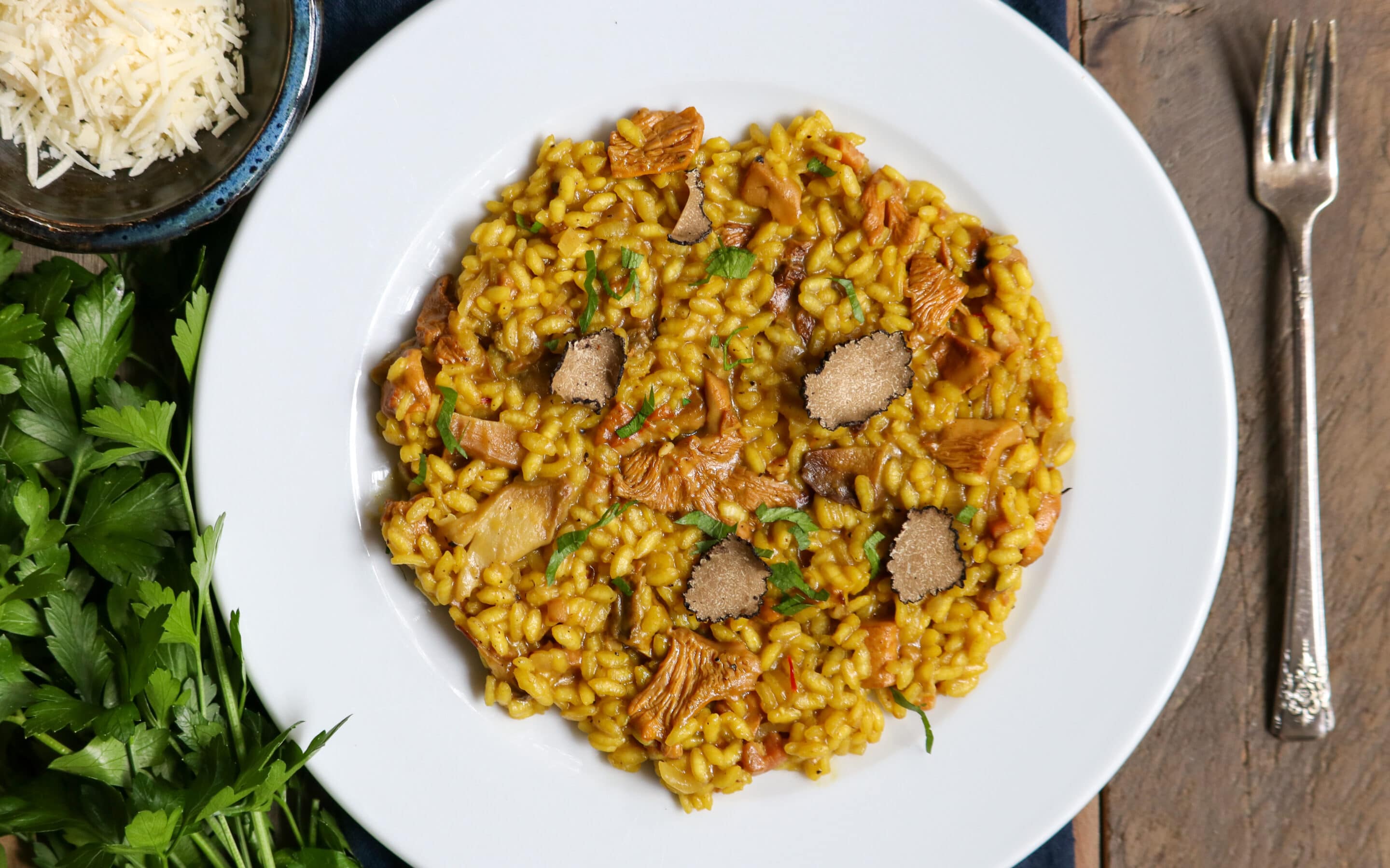 Chanterelle Mushroom risotto in a white bowl on a dinner table