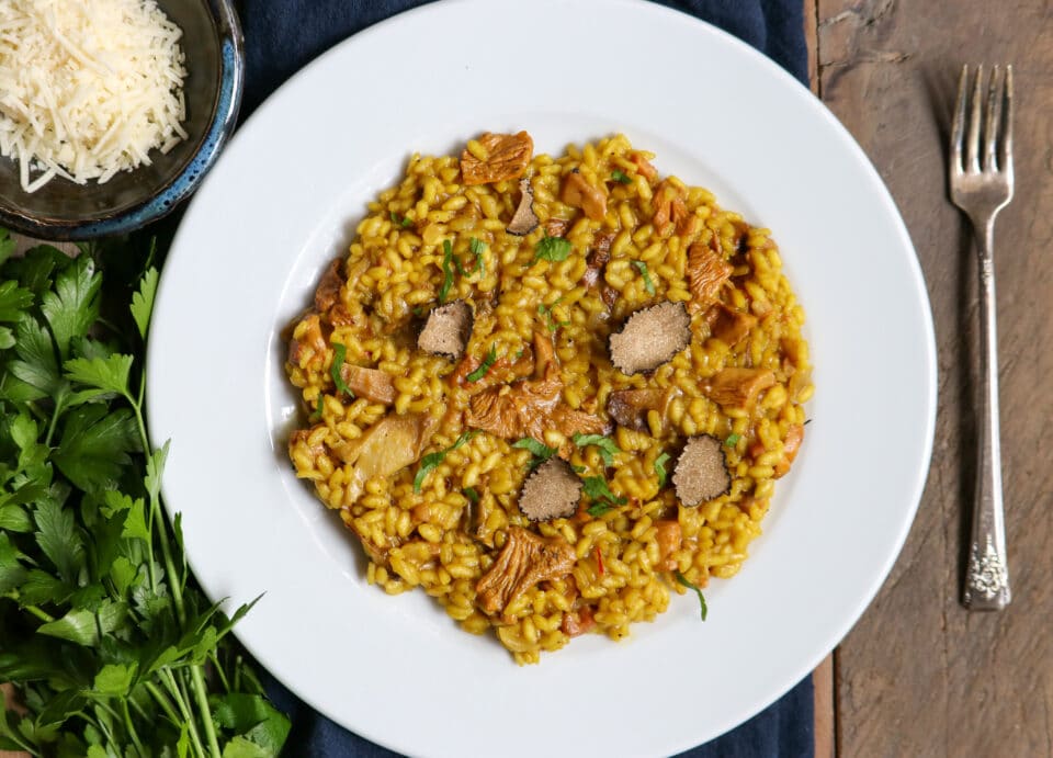 Chanterelle Mushroom risotto in a white bowl on a dinner table