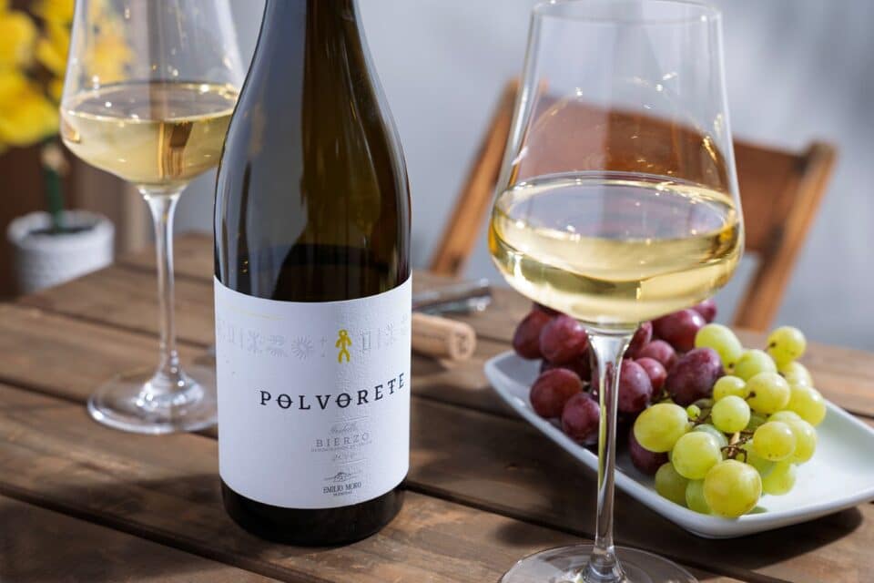 Polvorette Wine on a table with grapes and wine glasses