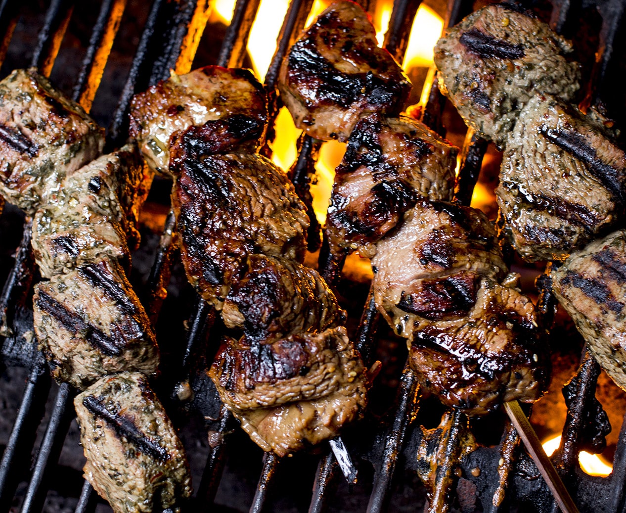 kabobs roasting on a grill