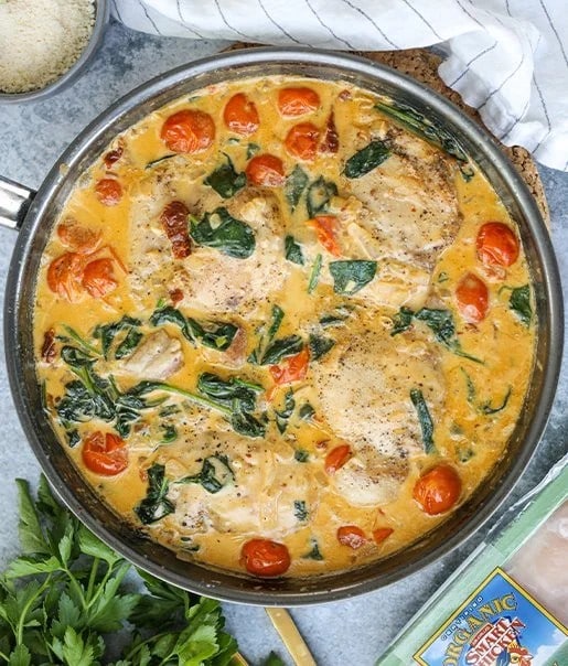 dish made with chicken thighs, spinach, and tomatoes