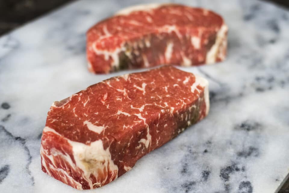 Dry aged New York Steak on a marbled surface