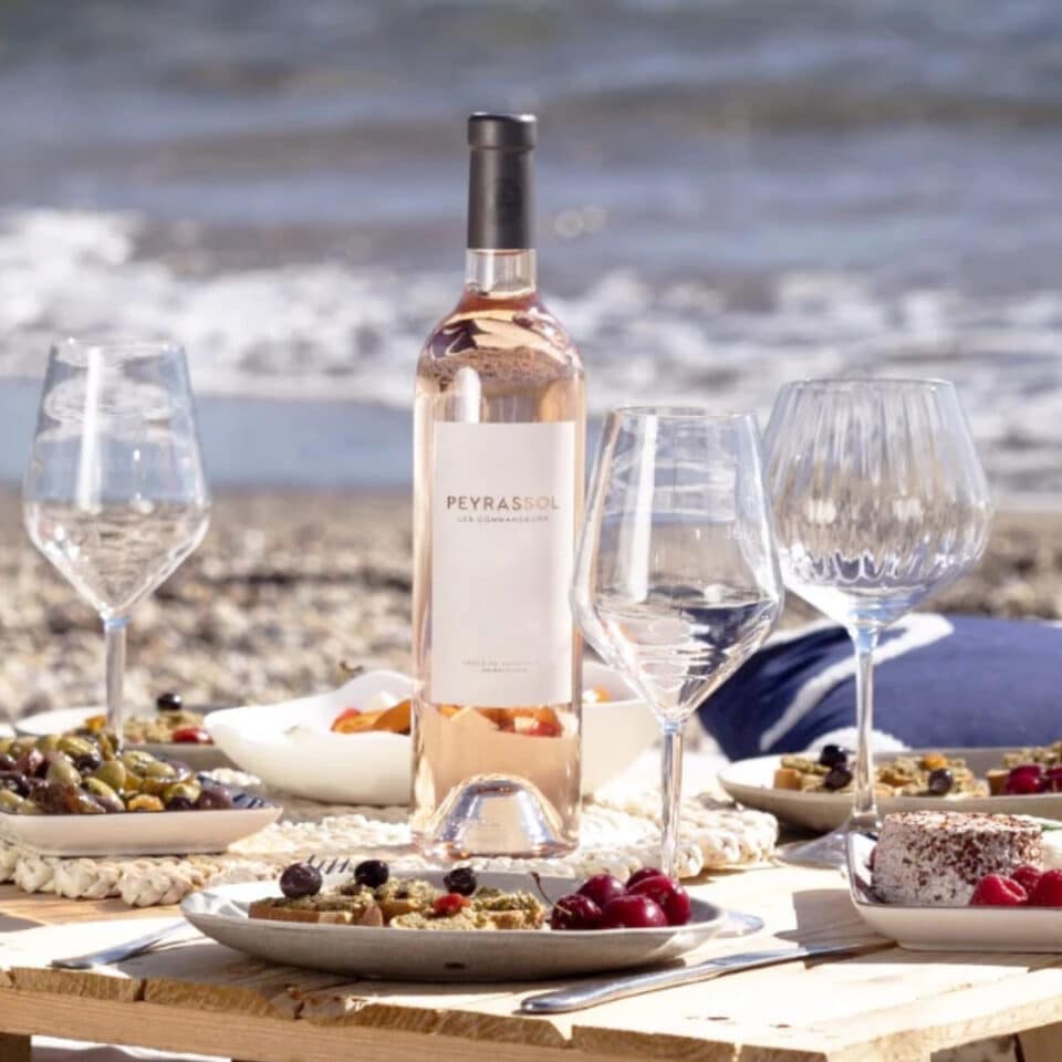 Peyrassol Commandeurs Rosé on a picnic table on the beach