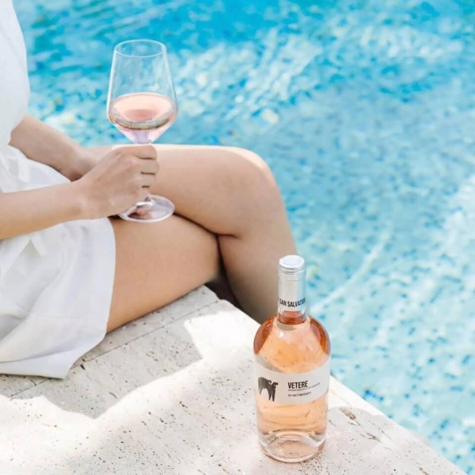 woman drinking san salvatore vetere by the pool