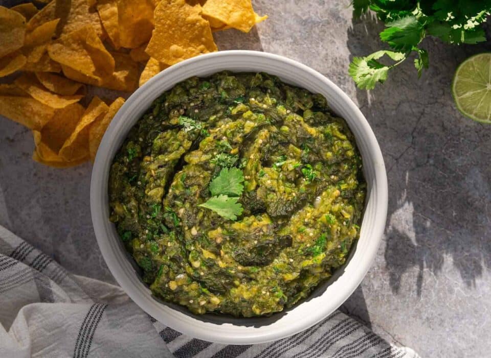 Green Chile Salsa in a bowl next to corn chips