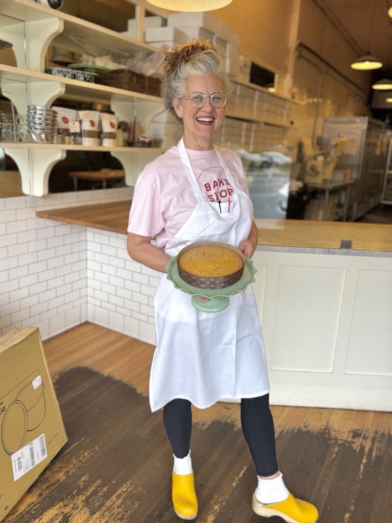 Woman holding a cake in a bakery