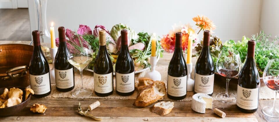 Wine bottles with cheese and bread on a table