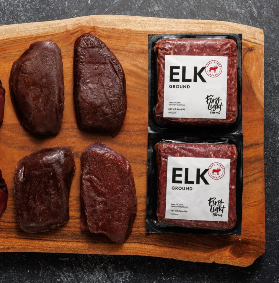 Ground elk and elk steaks on a wooden board