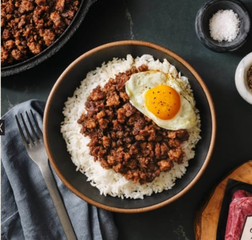 Meet and eggs on rice in a bowl