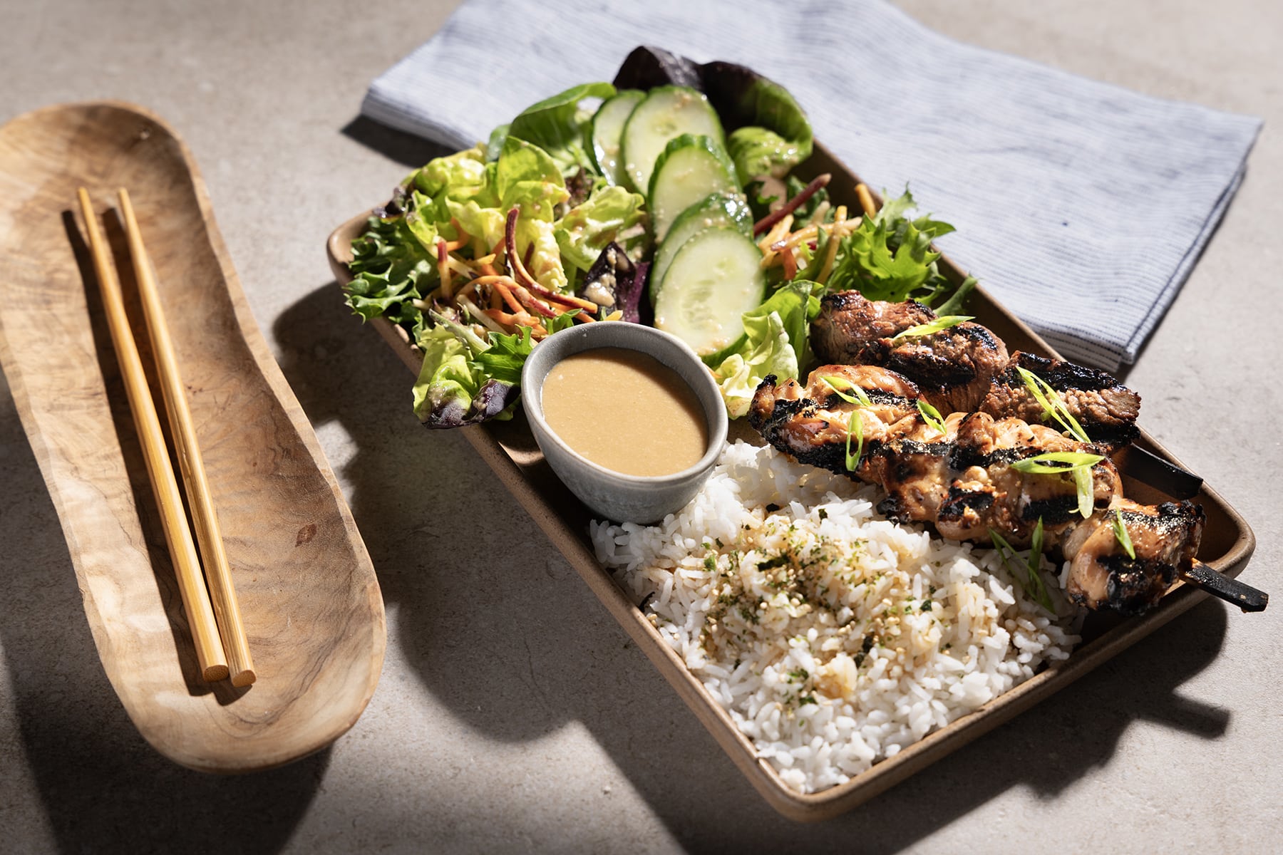 Zupan's bento plate with salad rice and meat skewers